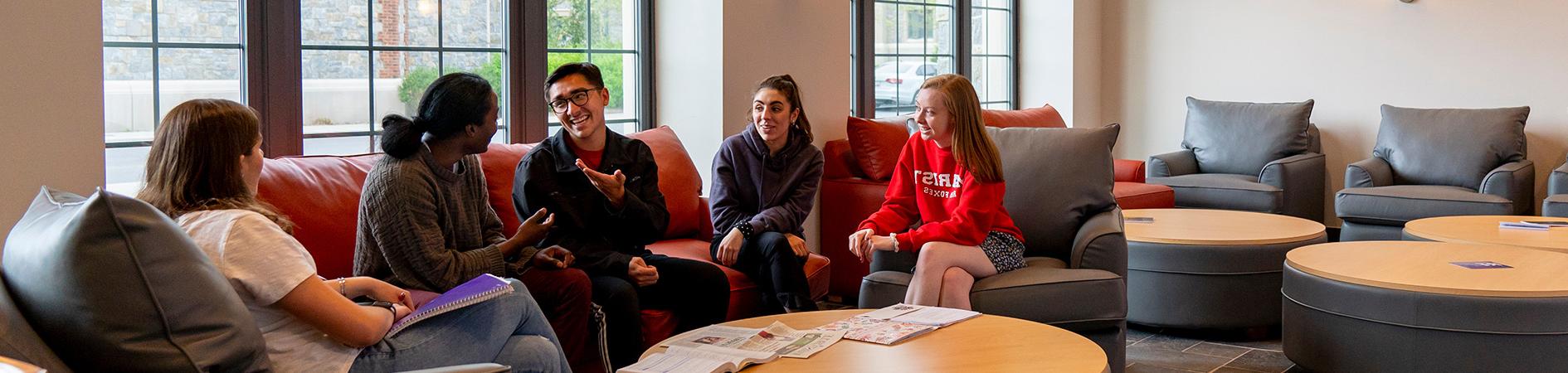 Photo of students talking in residence hall common area